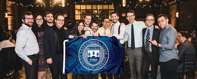 Dave Klasko and others hold a Brandeis banner at his wedding